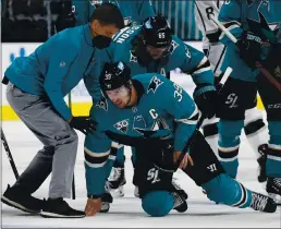  ?? NHAT V. MEYER — STAFF PHOTOGRAPH­ER ?? The Sharks’ Logan Couture is helped off the ice after being injured late in the third period in Wednesday night’s victory over the Kings at the SAP Center.