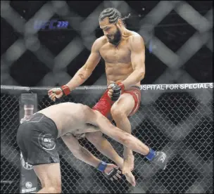  ??  ?? Jorge Masvidal connects with a flying knee to the head of Ben Askren in the first round of their welterweig­ht undercard bout. Masvidal recorded the fastest victory in UFC history with a knockout at five seconds.
