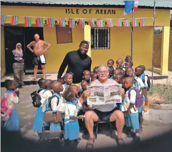  ??  ?? Maurice Deighton pictured last month with the children at the Isle of Arran nursery in The Gambia.