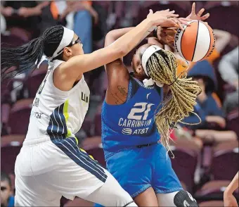  ?? SEAN D. ELLIOTT/THE DAY ?? Dallas Wings guard Allisha Gray (15) fouls Connecticu­t Sun forward DiJonai Carrington (21) during Tuesday night’s WNBA game at Mohegan Sun Arena. The two teams play again tonight at 7 p.m.