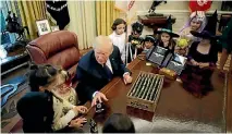  ?? PHOTO: REUTERS ?? President Donald Trump gives out Halloween treats to children of members of press and White House staff in the Oval Office of the White House.
