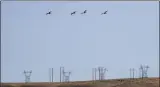  ?? ELAINE THOMPSON ?? In this Wednesday, Aug. 14, 2019photo, white pelicans take flight over power lines near the Hanford Reach National Monument near Richland, Wash.