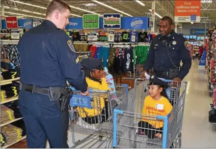  ?? SUBMITTED PHOTO ?? Chester County Cpl. Kevin Marvill, left, and Deputy Stanley McDaniel are shown with their young shoppers during the 2016 Shop with the Sheriff.