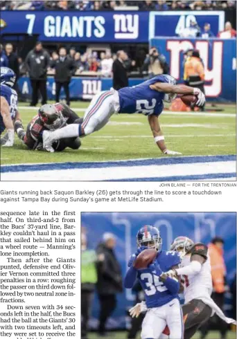  ?? JOHN BLAINE — FOR THE TRENTONIAN ?? Giants running back Saquon Barkley (26) gets through the line to score a touchdown against Tampa Bay during Sunday’s game at MetLife Stadium.