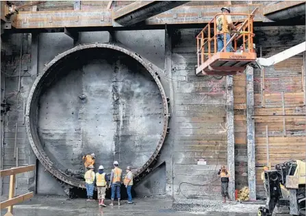  ?? Irfan Khan Los Angeles Times ?? WORKERS prepare for the machine known as “Angeli” to break through a dirt wall at the Grand Avenue Arts/Bunker Hill Station.