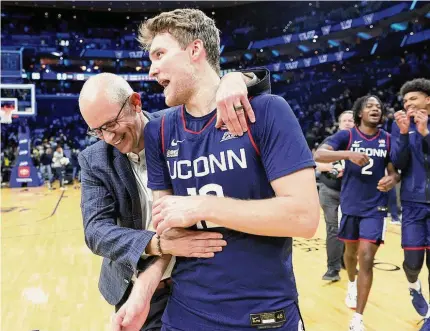  ?? Tim Nwachukwu/Getty Images ?? UConn coach Dan Hurley, left, and Cam Spencer react after defeating Villanova on Saturday night.