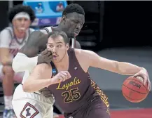  ?? Paul Sancya, The Associated Press ?? Loyola Chicago center Cameron Krutwig drives on Illinois center Kofi Cockburn during the first half Sunday in Indianapol­is.