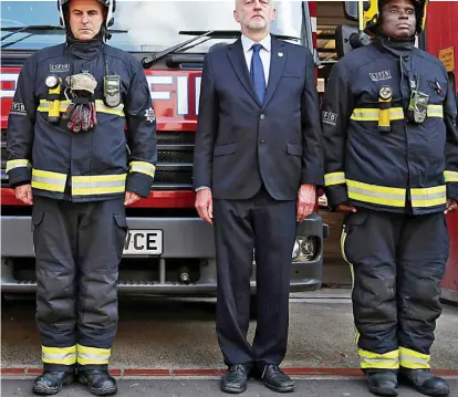  ??  ?? Minute of silence: Jeremy Corbyn at Islington Fire Station in North London yesterday