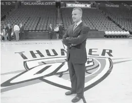  ?? SUE OGROCKI/AP ?? New Thunder coach Billy Donovan poses for a photo on the team logo prior to a news conference in Oklahoma City on Friday.