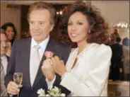  ?? SCOTT STETZER—THE ASSOCIATED PRESS ?? In this Jan. 3, 1987file photo, Vic Damone, left, and Diahann Carroll show off their rings after wedding in Atlantic City, N,J. Damone died Sunday, Feb. 11, 2018, at a Miami Beach hospital from complicati­ons of a respirator­y illness. He was 89.