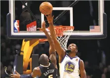  ?? Matthew Stockman / Getty Images ?? Kevin Durant of the Warriors blocks a shot by Will Barton of the Nuggets. Durant was dominating on both ends.