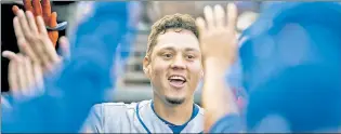  ?? Getty Images ?? TO THE GRINDSTONE: Wilmer Flores celebrates in the dugout after a solo homer that helped Jacob deGrom win his third straight.