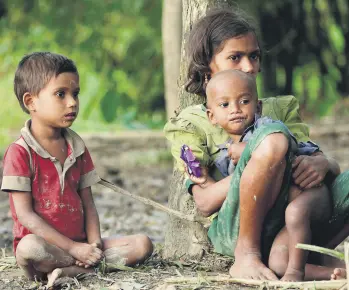 ??  ?? Rohingya children sit under a tree to take a upon arrival in Tuangiri, Teknaf, Bangladesh, Sept. 12.