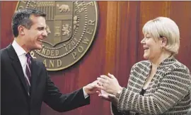  ?? Francine Orr Los Angeles Times ?? MAYOR ERIC GARCETTI introduces Marcie Edwards, who began her career with the DWP and whose father and grandfathe­r worked at the agency.