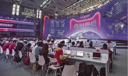  ?? BLOOMBERG PIC ?? Employees working on computers while monitoring live updates of sales figures during Alibaba Group Holding Ltd’s annual November 11 Singles’ Day online shopping event in Shenzhen last year. Citigroup estimates a record 158 billion yuan of sales for...