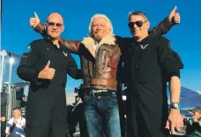  ?? AFP; AP ?? Above right, Virgin Galactic’s ‘Unity’ launches for a suborbital test flight on Thursday in the Mojave Desert, California. Above left, Richard Branson celebrates with pilots Rick Sturckow, left, and Mark Stucky after the flight