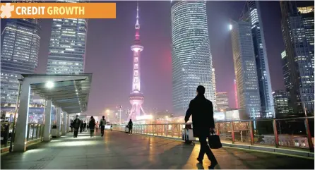  ?? — Reuters ?? A man walks on a bridge in the financial district of Pudong in Shanghai.