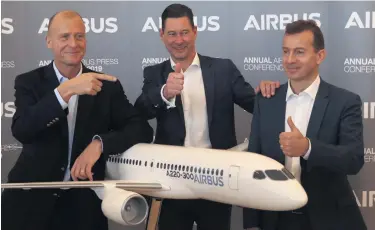  ??  ?? From left, Airbus CEO Tom Enders, CFO Harald Wilhelm and Airbus Commercial Aircraft president Guillaume Faury give the thumbs-up to the A220-300, the wings of which are made in Belfast by Bombardier