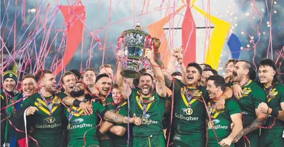  ?? ?? James Tedesco lifts the Rugby League World Cup trophy with teammates after taking down Samoa at Old Trafford. Picture: Getty Images