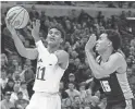  ?? CHARLES REX ARBOGAST/AP ?? Kansas guard Remy Martin shoots past Providence’s Justin Minaya during a Sweet 16 game on Friday in Chicago.