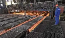  ?? CHINATOPIX VIA AP ?? A man works at Xiwang Special Steel in Zouping County in eastern China’s Shandong province. China’s steel mills, a target of President Donald Trump’s ire, supply half of the world’s output.