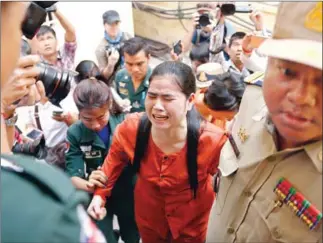  ?? MENEA HONG ?? Boeung Kak activist Tep Vanny is escorted by officials into the Supreme Court last year.
