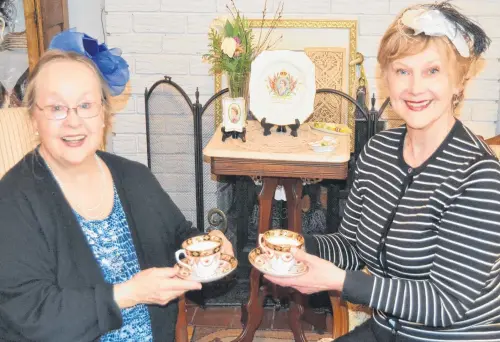  ?? SALLY COLE THE GUARDIAN ?? In Charlottet­own, Penelope Player, left, and Rowena Hickox prepare to lift their teacups in honour of the royal wedding of Prince Harry and Meghan Markle. The royal wedding took place Saturday at St. George’s Chapel at Windsor Chapel in Britain. •