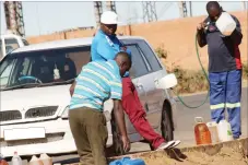  ??  ?? A motorist refuels at a dealer along Nketa Drive in Nketa recently. Despite the danger posed to property by keeping drums of fuel inside houses, some people continue doing so