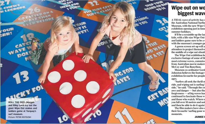  ?? Picture: PETER RISTEVSKI ?? ROLL THE DICE: Morgan and Riley Lunn try out the giant Wipe Out snakes and ladders game at Torquay’s surf museum.