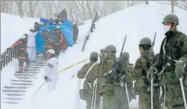  ?? AFP ?? Firefighte­rs carry a survivor they rescued from the site of the avalanche in Nasu town.