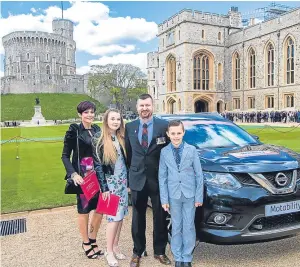  ??  ?? Paul Barrett with his family at Windsor Castle where he picked up the keys to his new Nissan X-Trail.