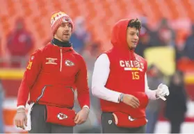  ?? Icon Sportswire via Getty Images 2018 ?? ThenKansas City QB Alex Smith (cap) and Patrick Mahomes warm up before the AFC wildcard game against the Titans in 2018. Smith, who eventually lost his job to Mahomes, “let Patrick into his world,” head coach Andy Reid said.