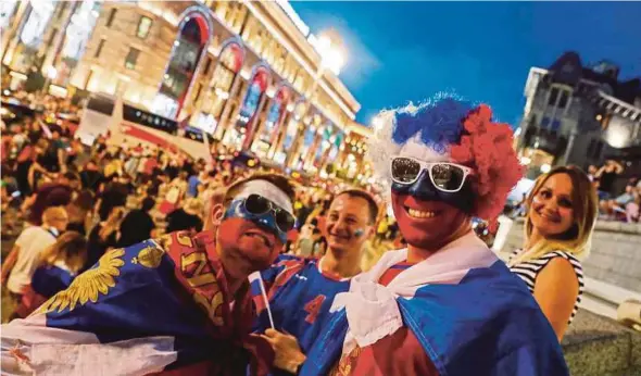  ?? EPA PIC ?? Russia supporters celebrate after the team beat Spain 4-3 on penalties in the World Cup last-16 in central Moscow on Sunday.