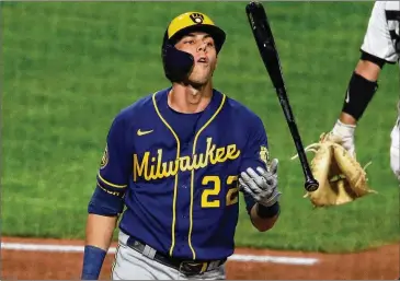  ?? GENE J. PUSKAR / ASSOCIATED PRESS ?? Brewers outfielder Christian Yelich tosses his bat as he walks back to the dugout after striking out against Pirates reliever Robbie Erlin on Wednesday. As of Thursday, the defending NL batting champ was 1 for 28 to start the delayed season, an .037 average that’s worst among qualified hitters.