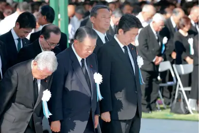  ?? AFP ?? Japan’s prime Minister shinzo Abe (right) offers a silent prayer during the 73rd anniversar­y memorial service for the atomic bomb victims at the peace Memorial park in hiroshima on Monday. —