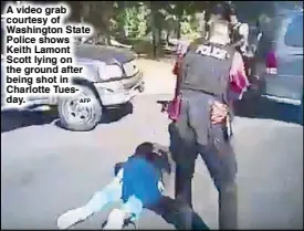  ?? AFP ?? A video grab courtesy of Washington State Police shows Keith Lamont Scott lying on the ground after being shot in Charlotte Tuesday.