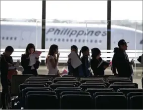  ?? NOEL CELIS/AFP ?? Filipina workers returning home from Kuwait on February 18 arrive at Manila Internatio­nal Airport.