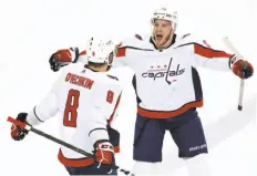  ?? Ike Carlson / Getty Images ?? Alex Ovechkin (8) of the Capitals celebrates with teammate John Carlson after scoring a goal in the first period in a 4-2 victory over Tampa Bay.