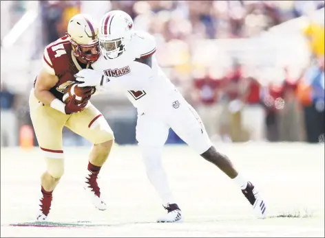  ?? Maddie Meyer / Getty Images ?? UMass’s Brice McAllister tackles Boston College’s Jake Burt at Alumni Stadium on September 1 in Chestnut Hill, Massachuse­tts.