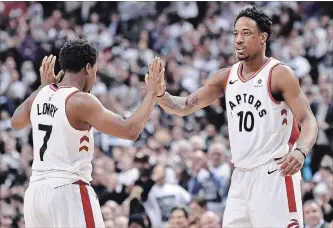  ?? NATHAN DENETTE THE CANADIAN PRESS ?? Raptors guard Kyle Lowry and teammate DeMar DeRozan (10) celebrate a basket against the Washington.