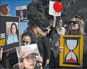  ?? Oded Balilty The Associated Press ?? Relatives and supporters of the Israeli hostages held in the Gaza Strip by Hamas terrorists attend a march calling for their release Friday in Tel Aviv, Israel.