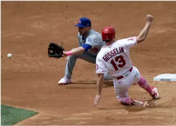  ?? AP Photo/Alex Gallardo ?? Los Angeles Dodgers second baseman Gavin Lux, left, waits for the throw before tagging out Los Angeles Angels’ Phil Gosselin on a steal attempt during the third inning of a baseball game in Anaheim, Calif., on Sunday.