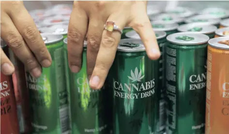  ?? Reuters ?? Expo-goers reach out for energy drinks, made from cannabis, on display at the opening of the four-day Cannabis Expo in Pretoria. | SIPHIWE SIBEKO