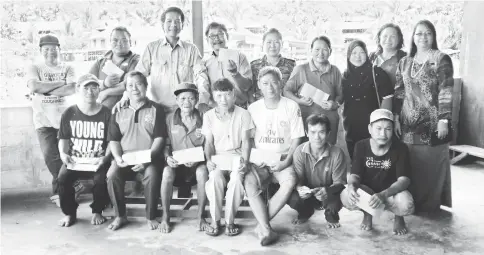  ??  ?? Dennis (back row – third left) with the victims, Maureen (fourth right) and officers from Miri Welfare Department after the presentati­on.