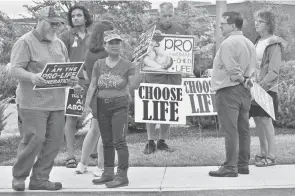  ?? ENQUIRER FILE ?? Anti-abortion rights advocates gather outside of the Mason Municipal Center before a City Council meeting in August.