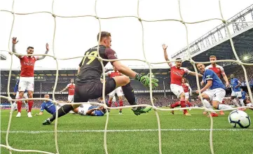  ??  ?? Everton’s English defender Phil Jagielka (3R) scores the opening goal past Arsenal’s German goalkeeper Bernd Leno during the match at Goodison Park. - AFP photo