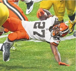  ?? DON WRIGHT/ASSOCIATED PRESS ?? Cleveland’s Kareem Hunt (27) is brought down during a playoff game last Sunday against Pittsburgh. Hunt, a former Kansas City Chief, faces his former team in Sunday’s playoff action. The two teams don’t play often, but they nonetheles­s have many common threads.