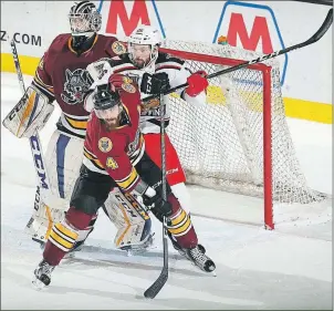  ?? ROSS DETTMAN/CHICAGO WOLVES ?? Chicago Wolves defenceman Morgan Ellis, 4, battles with a member of the Grand Rapids Griffins for position during a 2016-17 American Hockey League contest.