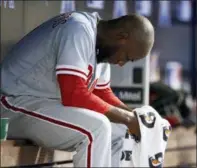  ?? BRYNN ANDERSON — THE ASSOCIATED PRESS ?? Philadelph­ia Phillies starting pitcher Enyel De Los Santos sits in the dugout during the fifth inning of a baseball game against Miami Marlins, Sunday in Miami.