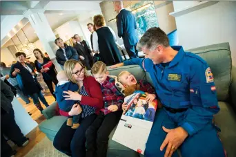  ?? @IMartensHe­rald Herald photo by Ian Martens ?? Three year old Leo, who was a STARS patient as an infant, shares a laugh with STARS base director Jeff Morris as his mom, Mandy DeCecco-Kolebaba, and brothers Jack and Jude attend the STARS Lottery launch Thursday at the Lethbridge show home.